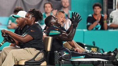Miami Dolphins wide receiver Tyreek Hill, right font, puts his arms up as he is carted off the field after suffering an unknown lower leg injury in the second half of an NFL football game against the New York Jets, Monday, Sept. 29, 2025, in Miami Gardens, Florida. (AP) Miami Dolphins wide receiver Tyreek Hill, right font, puts his arms up as he is carted off the field after suffering an unknown lower leg injury in the second half of an NFL football game against the New York Jets, Monday, Sept. 29, 2025, in Miami Gardens, Florida. (AP)
