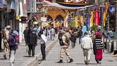 Security personnel keeping a watch at a market during the four-hour relaxation in the curfew in Leh on Tuesday. (PTI Photo)
