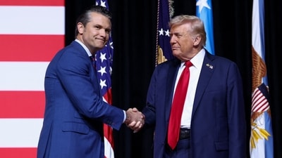 President Donald Trump shakes hands with Defense Secretary Pete Hegseth during a meeting of senior military leaders at Marine Corps Base Quantico in (REUTERS)