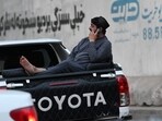 An Afghan man speaks on a mobile phone as he sits on the boot of a vehicle in Kabul on October 1, 2025. (Photo by Wakil KOHSAR / AFP) An Afghan man speaks on a mobile phone as he sits on the boot of a vehicle in Kabul on October 1, 2025. (Photo by Wakil KOHSAR / AFP)