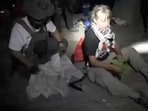A screengrab from a video shows Swedish activist Greta Thunberg sitting next to a person wearing tactical gear, as vessels of the Global Sumud Flotilla are being intercepted by Israeli security forces, October 1, 2025. 