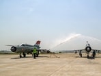Indian Air Force MiG-21 aircraft receive water salute during the decommissioning ceremony at the Chandigarh air force station. Indian Air Force MiG-21 aircraft receive water salute during the decommissioning ceremony at the Chandigarh air force station.