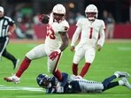 Arizona Cardinals running back Trey Benson (33) runs against Seattle Seahawks cornerback Devon Witherspoon (21)