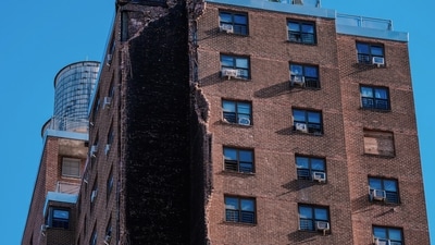 Firefighters stand on the roof of a building that partially collapsed in the Bronx borough of New York, Wednesday (AP) Firefighters stand on the roof of a building that partially collapsed in the Bronx borough of New York, Wednesday (AP)