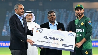 Mohsin Naqvi awards Salman Ali Agha the runners-up cheque from the Asia Cup. (AFP) Mohsin Naqvi awards Salman Ali Agha the runners-up cheque from the Asia Cup. (AFP)