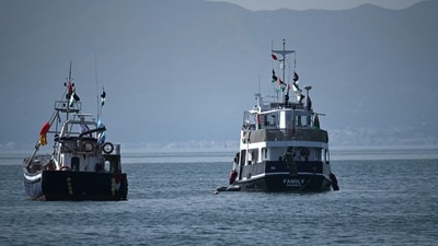 A ship (R), known as the "Family" and is part of the Global Sumud Flotilla, is anchored off the coast of the village of Sidi Bou Said on September 9, 2025. (Photo by FETHI BELAID / AFP) (AFP)