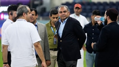 Pakistan's Minister of Interior Mohsin Naqvi, center, stands with officials on the field after India won the Asia Cup cricket final against Pakistan at Dubai International Cricket Stadium. (AP)