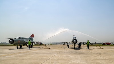 Indian Air Force MiG-21 aircraft receive water salute during the decommissioning ceremony at the Chandigarh air force station. (PIB)
