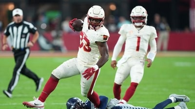 Arizona Cardinals running back Trey Benson (33) runs against Seattle Seahawks cornerback Devon Witherspoon (21) (IMAGN IMAGES via Reuters Connect)