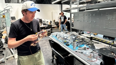 Steve Simoni, co-founder of Allen Control Systems (ACS), which makes an AI-powered turret for machine guns called the Bullfrog, looks at a circuit board at ACS headquarters in Austin, Texas. (REUTERS File)