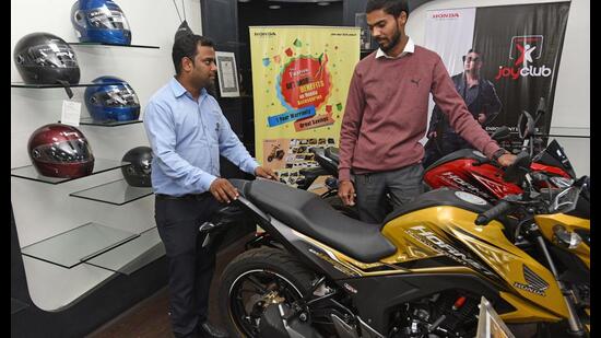 Pune, India - Dec. 7, 2018: Customers checking two wheelers at a bike showroom on JM road in Pune, India, on Friday, December 7, 2018. (Photo by Pratham Gokhale/Hindustan Times) (Pratham Gokhale/HT Photo)
