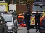Emergency personnel work at the scene, after a reported attack in which a car was driven at pedestrians and one person was stabbed near a synagogue in north Manchester, Britain