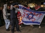 Pro-Palestinian demonstrators burn a defaced Israeli flag as they protest after Israel intercepted some of the vessels of the Global Sumud Flotilla aiming to reach Gaza and break Israel's naval blockade, in Thessaloniki, Greece, October 2, 2025. 