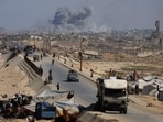 Smoke rises during an Israeli military operation as displaced Palestinians flee Gaza City, in the central Gaza Strip, on September 30, 2025.