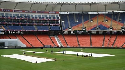 Groundsmen work at the Narendra Modi Stadium in Ahmedabad. (AFP)