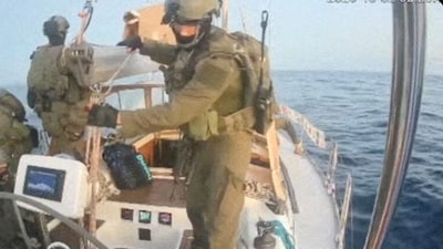 Israeli navy forces aboard the Gaza-bound vessel Oxygono, part of the Global Sumud Flotilla (via REUTERS)