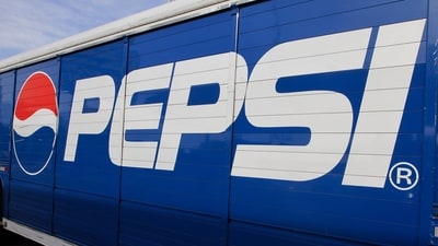 A Pepsi logo is seen on a delivery truck. When the Pepsi-Cola Company was founded in 1902, the absence of artificial dyes was a point of pride. (AP) A Pepsi logo is seen on a delivery truck. When the Pepsi-Cola Company was founded in 1902, the absence of artificial dyes was a point of pride. (AP)