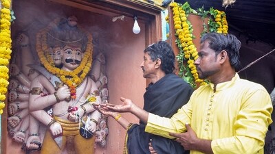 Devotees offer pray to Ravana on the day of Vijayadashami as the temple opens once a year on the day of Dussehra in Shivala. (ANI)