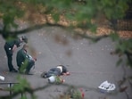 Ambulance incident workers process the body of a man, believed to be the attacker, at the scene, after a report of an incident in which a car was driven at pedestrians and a stabbing attack outside a synagogue, in north Manchester, Britain. REUTERS/Hannah McKay