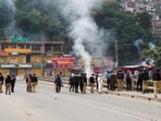 Police officers stand on a bridge, as they stop the protesters of the Awami Action Committee, during a protest following a shutter-down strike in Muzaffarabad, the capital of Pakistan-occupied Kashmir. 