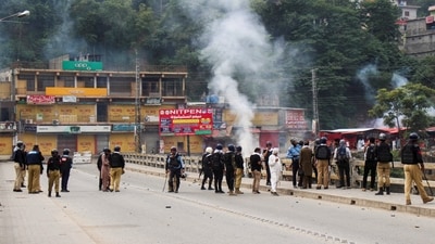 Police officers stand on a bridge, as they stop the protesters of the Awami Action Committee, during a protest following a shutter-down strike in Muzaffarabad, the capital of Pakistan-occupied Kashmir. (REUTERS)