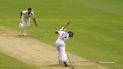 Justin Greaves being bowled by India's Jasprit Bumrah on day one of the first test cricket match between India and West Indies. (PTI)