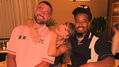 Taylor Swift and Travis Kelce posed with a fan at his restaurant. Taylor Swift and Travis Kelce posed with a fan at his restaurant.