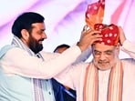 Haryana chief minister Nayab Singh Saini felicitates Union home minister Amit Shah with a safa during the state-level exhibition on new criminal laws in Kurukshetra on Friday. (PTI) Haryana chief minister Nayab Singh Saini felicitates Union home minister Amit Shah with a safa during the state-level exhibition on new criminal laws in Kurukshetra on Friday. (PTI)