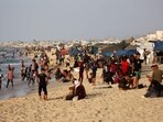Displaced Palestinians sit on the beach in front of their tents as others swim in the Mediterranean sea in Khan Yunis in the southern Gaza Strip on October 3, 2025. Displaced Palestinians sit on the beach in front of their tents as others swim in the Mediterranean sea in Khan Yunis in the southern Gaza Strip on October 3, 2025.