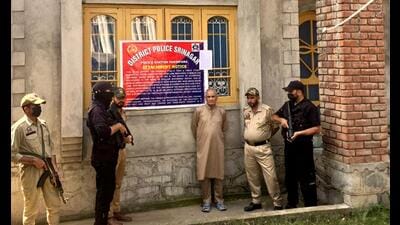 Police and security personnel stand outside the property of Sajad Ahmad Sheikh, head of The Resistance Front (TRF) terror outfit, which was attached by the police under the Unlawful Activities (Prevention) Act, in Srinagar, on Saturday. (PTI) Police and security personnel stand outside the property of Sajad Ahmad Sheikh, head of The Resistance Front (TRF) terror outfit, which was attached by the police under the Unlawful Activities (Prevention) Act, in Srinagar, on Saturday. (PTI)