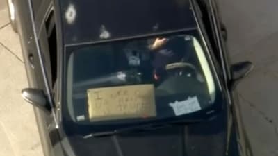 A sign reading ‘I need your help’ was reportedly seen in the vehicle along with another which said “Don't want to hurt nobody.” (X/@Raw_Reporting)