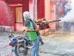 A municipal corporation worker fumigates a residential area in Delhi. (PTI) A municipal corporation worker fumigates a residential area in Delhi. (PTI)