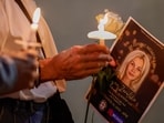 Community members hold candles as they gather for a vigil honoring the life of Iryna Zarutska, who was fatally stabbed on a commuter train last month, Monday, Sept. 22, 2025, in Charlotte, N.C. (AP Photo/Nell Redmond)