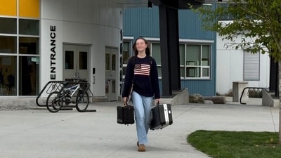A Canadian student wearing a sweater with an American flag on it. (X/@BillboardChris)