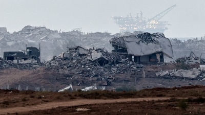 Destroyed buildings in Gaza, with an oil rig in the distance, as seen from Israel,&nbsp; (Reuters)
