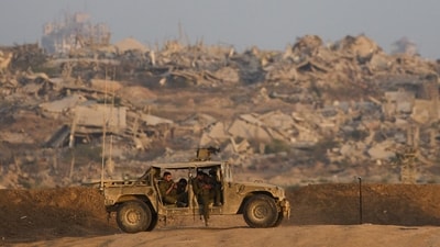 Israeli soldiers rest in a hammer on a hill overlooking Gaza Strip in southern Israel, Sunday, Oct. 5 (AP/Ariel Schalit) Israeli soldiers rest in a hammer on a hill overlooking Gaza Strip in southern Israel, Sunday, Oct. 5 (AP/Ariel Schalit)