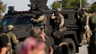 Federal law enforcement agents arrive on an armored tactical vehicle as hundreds of protesters gather near an Immigration and Customs Enforcement (ICE) facility opposing the detention of undocumented immigrants following President Donald Trump'ss order to increase federal presence and step up immigration enforcement through the Department of Homeland Security in Broadview, Illinois (Photo by OCTAVIO JONES / AFP) (AFP) Federal law enforcement agents arrive on an armored tactical vehicle as hundreds of protesters gather near an Immigration and Customs Enforcement (ICE) facility opposing the detention of undocumented immigrants following President Donald Trump'ss order to increase federal presence and step up immigration enforcement through the Department of Homeland Security in Broadview, Illinois (Photo by OCTAVIO JONES / AFP) (AFP)