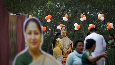 People stand near cutouts of Delhi chief minister Rekha Gupta (PTI) People stand near cutouts of Delhi chief minister Rekha Gupta (PTI)
