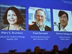A screen showing the photos of Mary E Brunkow, Fred Ramsdell and Shimon Sakaguchi  who were awarded the Nobel Prize in Medicine or Physiology, at the Nobel Assembly of the Karolinska Institutet, in Stockholm, Sweden, Monday, Oct. 6, 2025. (Claudio Bresciani/TT News Agency via AP)