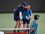 Jannik Sinner is helped by a medical trainer during his men's singles match against Tallon Griekspoor. Jannik Sinner is helped by a medical trainer during his men's singles match against Tallon Griekspoor.