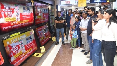 Patna: People watch the live telecast of Election Commission's press conference regarding the 2025 Bihar Assembly elections, at a showroom in Patna. (Photo by Santosh Kumar/ Hindustan Times)