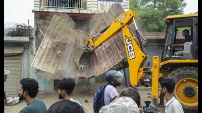 An excavator being used to demolish encroachments during a drive by municipal corporation, in Bareilly, Monday. (PTI Photo) An excavator being used to demolish encroachments during a drive by municipal corporation, in Bareilly, Monday. (PTI Photo)