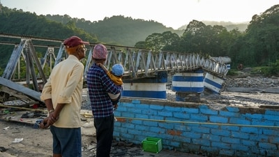 Darjeeling: Locals look at the damaged Dudhia iron bridge after landslides and heavy rainfall, in Darjeeling district, West Bengal, Monday, Oct. 6, 2025. (PTI Photo)(PTI10_06_2025_000297A) (PTI) Darjeeling: Locals look at the damaged Dudhia iron bridge after landslides and heavy rainfall, in Darjeeling district, West Bengal, Monday, Oct. 6, 2025. (PTI Photo)(PTI10_06_2025_000297A) (PTI)