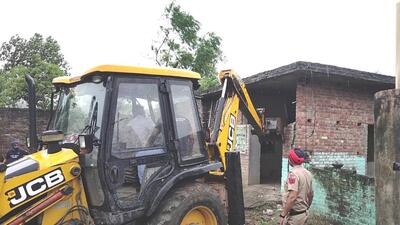 The house of a drug peddler being demolished in Tanda town of Hoshiarpur district on Monday. (Harpreet Kaur/HT)