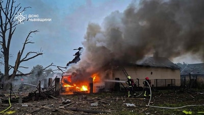 In this handout photograph taken and released by the Ukrainian Emergency Service on October 5, 2025, Ukrainian rescuers work to extinguish a fire at the site of an air attack at an undisclosed location in the Lviv region, amid the Russian invasion of Ukraine. (Photo by Handout / UKRAINIAN EMERGENCY SERVICE / AFP) / RESTRICTED TO EDITORIAL USE - MANDATORY CREDIT "AFP PHOTO / UKRAINIAN EMERGENCY SERVICE" -  HANDOUT - NO MARKETING NO ADVERTISING CAMPAIGNS - DISTRIBUTED AS A SERVICE TO CLIENTS - AFP CANNOT INDEPENDENTLY VERIFY THE AUTHENTICITY OR LOCATION, DATE, AND CONTENT OF THESE IMAGES. / (AFP)