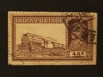 A commemorative postal stamp of British India depicting King George V and a mail train. Pious Labor by Amanda Lanzillo quotes from Kalid-i-san‘at ( The Key to Industry , 1890) by Hakimuddin, who worked at the North Western State Railway Locomotive Department at Sukkur (Sindh). He refers to the “train of endless progress”. (Shutterstock)