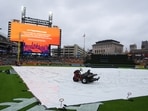 A tarp covers the field as rain falls while a message is seen on a video board alerting fans the start of Game 3 of baseball's American League Division Series between the Detroit Tigers and the Seattle Mariners will be delayed Tuesday, Oct. 7, 2025, in Detroit. A tarp covers the field as rain falls while a message is seen on a video board alerting fans the start of Game 3 of baseball's American League Division Series between the Detroit Tigers and the Seattle Mariners will be delayed Tuesday, Oct. 7, 2025, in Detroit.