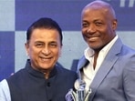 Indian cricket legend Sunil Gavaskar (L) presents the lifetime achievement award to ex-West Indies stalwart Brian Lara at the CEAT awards in Mumbai on Tuesday. (PTI)