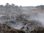 Displaced Palestinian children search of items that could be used as fuel for cooking amid a pile of burning garbage at the Bureij camp for refugees in the central Gaza Strip Displaced Palestinian children search of items that could be used as fuel for cooking amid a pile of burning garbage at the Bureij camp for refugees in the central Gaza Strip