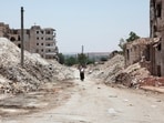 A man walks through the destruction in the city of Aleppo, Syria